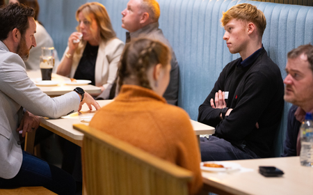 UCD alumni and students sitting together during a mentoring event.